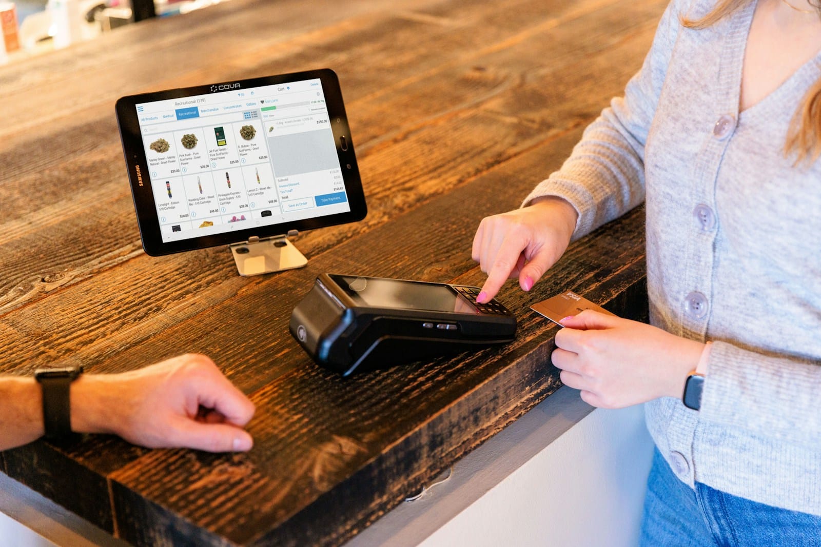 a woman is paying for her cell phone at the cash register, Pennsylvania Medical Marijuana